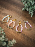 Custom faux pearl keychains in blue, pink, and purple with gold-tone clasps and letter beads spelling Dog Mom and Avo